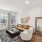 Bright living room with large windows, natural light flooding the space, and modern furniture